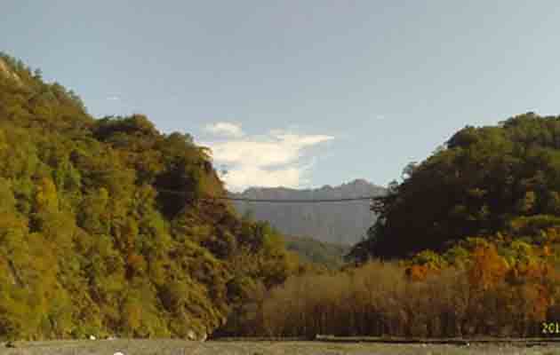 Overlooking the suspension bridge and Nenggao peaks from the riverbed of Aowanda Creek